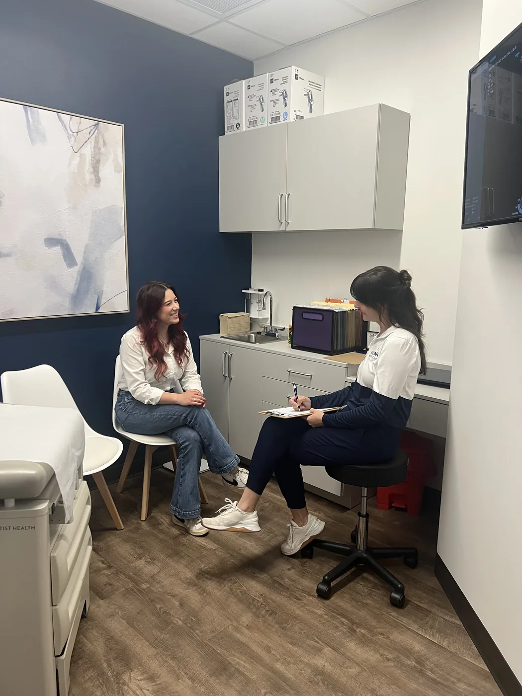 Two Alliance staff members in conversation with a client