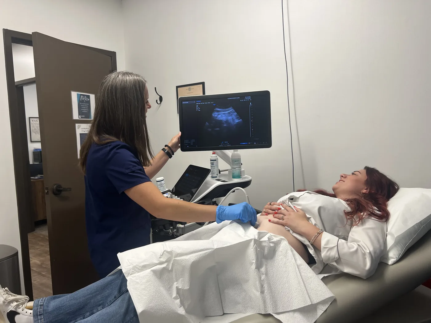 A sonographer performing an ultrasound examination